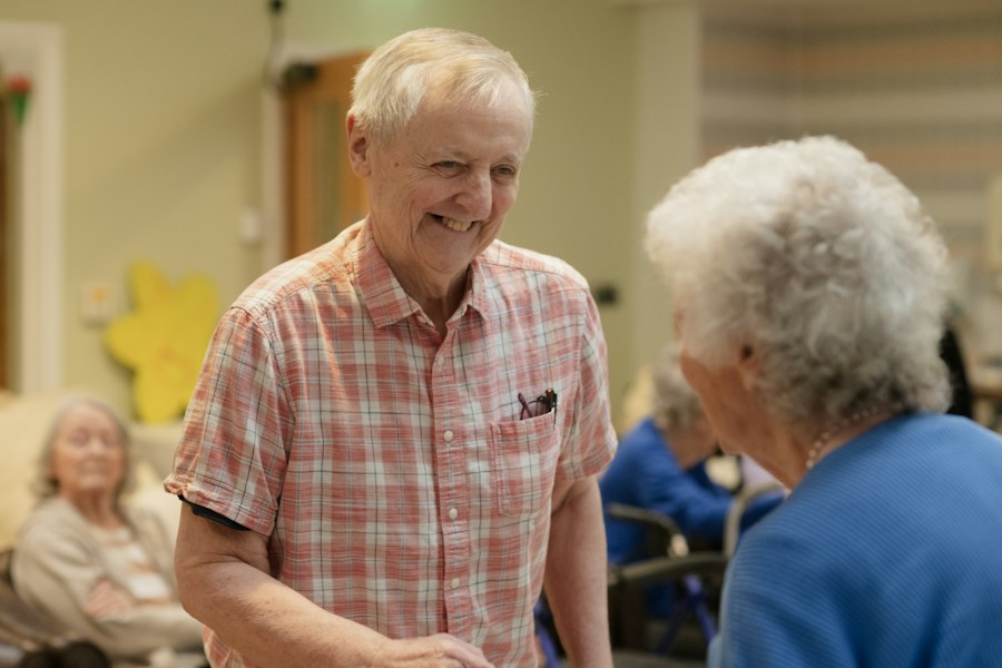 Two smiling seniors talking in a common room